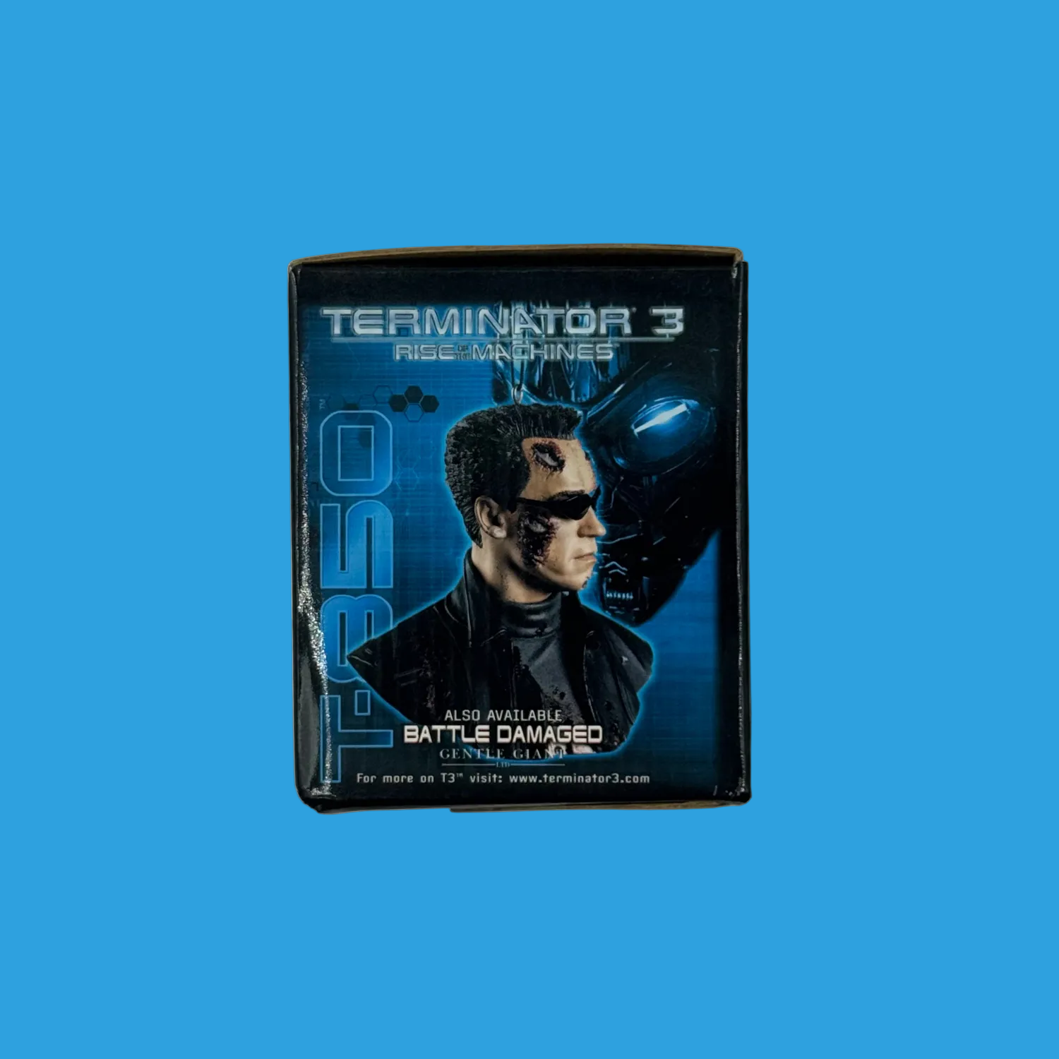 A Terminator 3 'I Am Labeled' collectible pin on a plain white background. The pin features a stylized graphic of the character with a blue Terminator helmet behind him.
