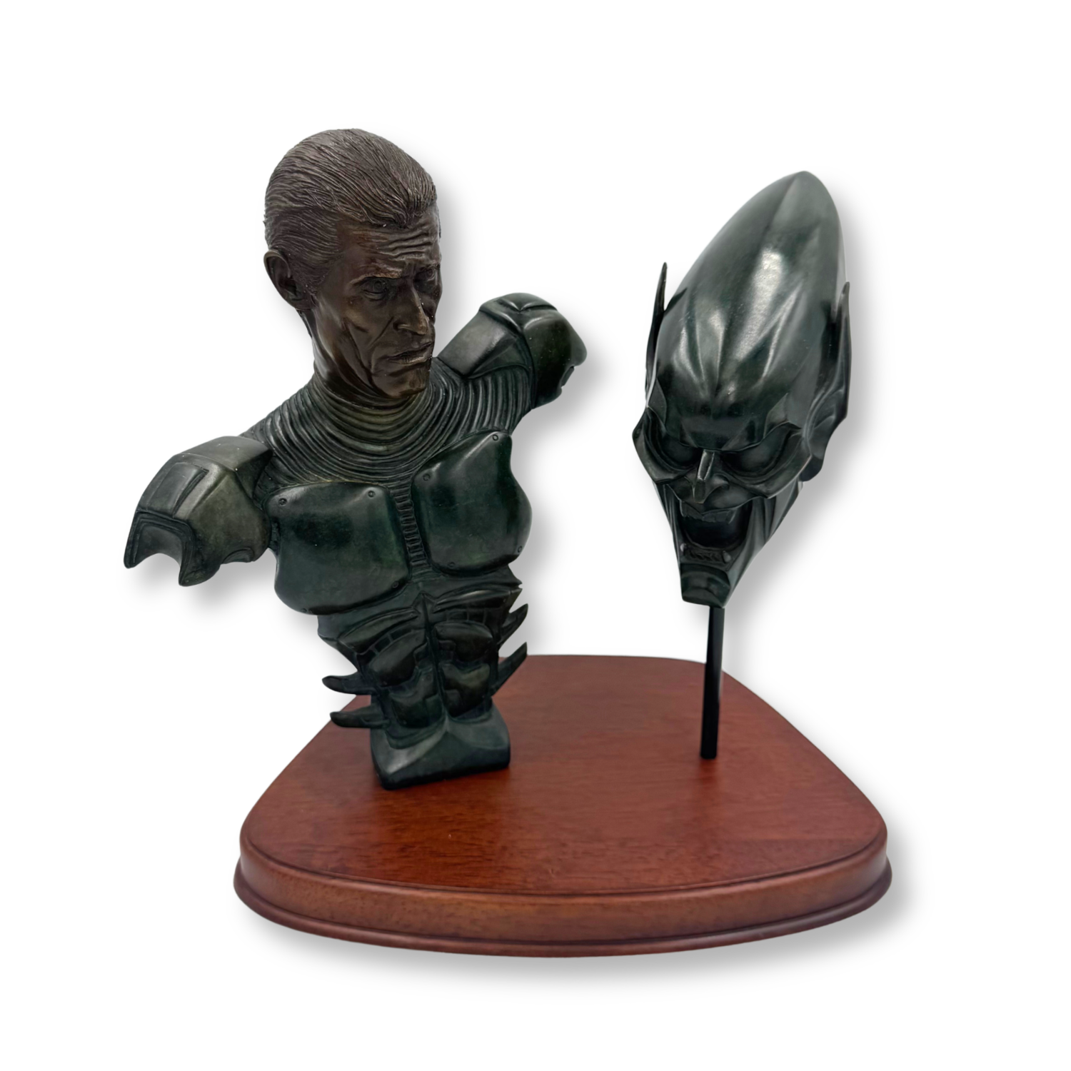 A dark metallic bust sculpture of actor Willem DaFoe as The Green Goblin from Sony Pictures Spider-Man on a wooden display base, shown against a plain white background.